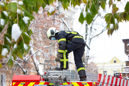 firefighter man works on his fire truck. fire safety serviceの写真素材