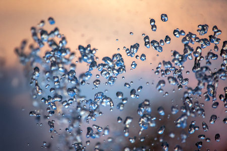 flying drops of water fountain close-up on the background of the sky