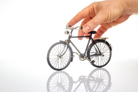 man hand on a bicycle model on a white background. cycling conceptの写真素材