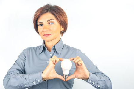 beautiful woman with LED lamp in hands on a white backgroundの写真素材