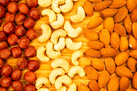 assorted nuts on a kitchen wooden board. vitamin vegetarian foodの写真素材