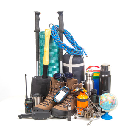 Items for tourism and hiking near a tourist backpack on a white background. set of equipment for tourism and travelの写真素材