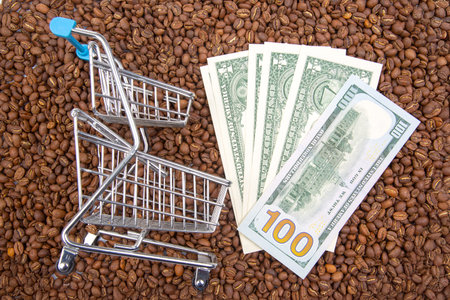 The cost of coffee visualized: a shopping cart on coffee beans with cash, symbolizing coffee pricing, consumer spending, and business trends.の写真素材
