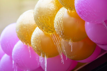 icicles on frozen colored inflatable holiday balls. winter weather season. street interior detailsの写真素材