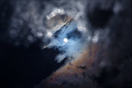 the moon shining through the cloudsの写真素材