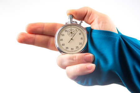 hand with a mechanical analog stopwatch on a white background. Time part precision. Measurement of the speed intervalの写真素材
