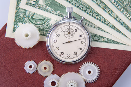 mechanical stopwatch on the background of dollars. Part time accuracy for business. business and finance time.の写真素材
