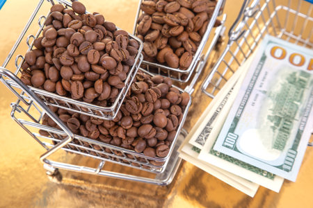 A stack of $100 bills lies beneath a cart of coffee beans on a golden backdrop, illustrating the lucrative coffee market and financial gainの写真素材