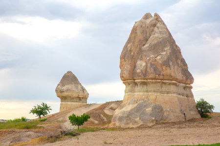 Bizarre rock formations dominate the landscape of Cappadocia, Turkey, showing unique natural sculptures.の写真素材