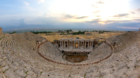 Located in Turkey, this ancient Roman theater showcases impressive architecture and stunning sunset views.の写真素材