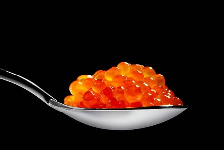 Red caviar isolated on black backgroundの写真素材