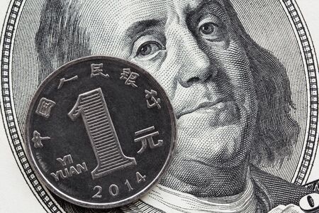 Global economics concept : chinese and american currency together. Focus on coin.の写真素材