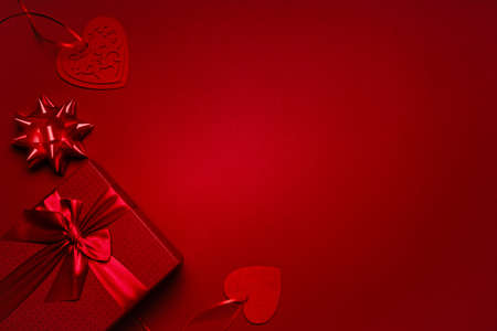 Red box with ribbon, with hearts on a red background with copyspace. Valentine's Day gift, postcard, empty space for your text.の写真素材