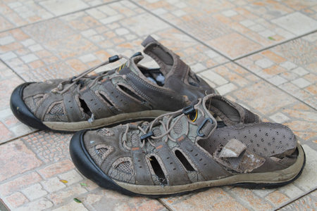 Shoes, couple, old, worn, tourist, broken back, brown, on the tileの写真素材