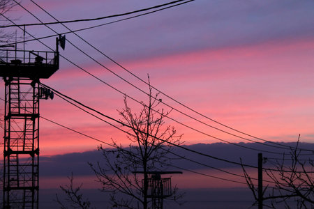 sunset over the sea, very beautiful, saturated colors, clear separation lines, mast, wiresの写真素材