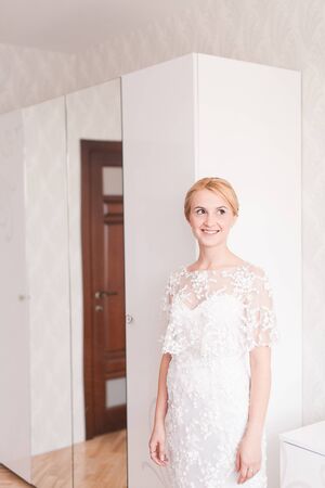 Gorgeous bride with wedding bouquet makeup and hairstyle in bridal dress.の写真素材