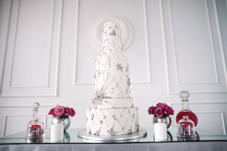 White cake stands on a table with decorationsの写真素材