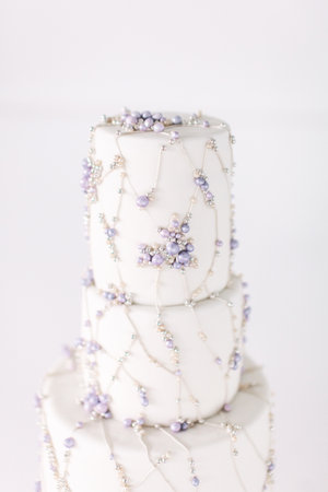 White cake stands on a table with decorationsの写真素材