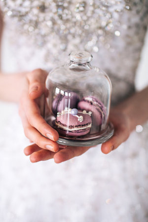 A girl holding a glass of macaroonsの写真素材