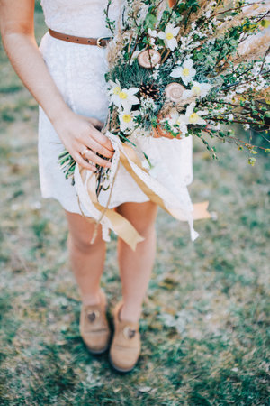The bride is holding a bridal bouquetの写真素材