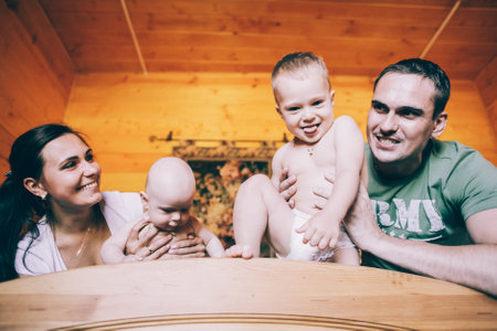 A happy family with kids in the bedroomの写真素材