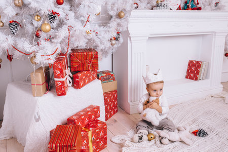 child with christmas presents in the living roomの写真素材