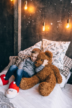 little boy and toy bearの写真素材