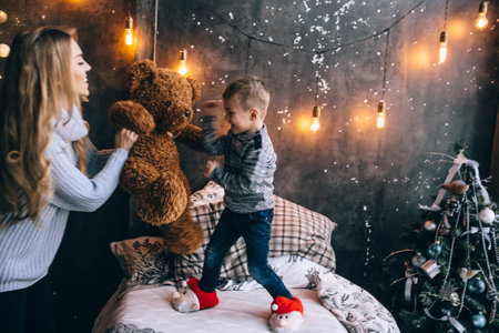 boy and mother playing with teddy bearの写真素材