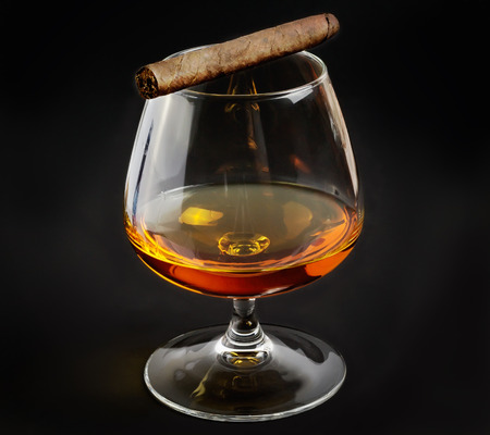 Fragrant cigar on glass with whiskeyの写真素材