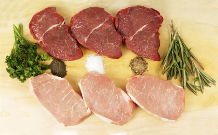 fresh beef and pork on board with spicesの写真素材