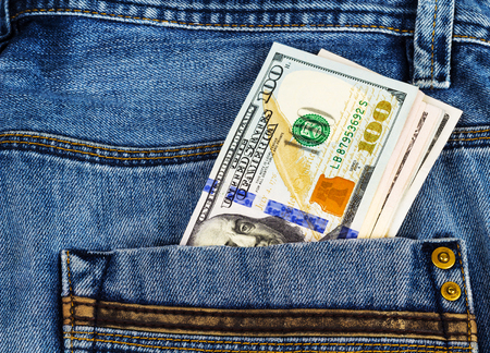 Dollars in the pocket of jeans trousersの写真素材