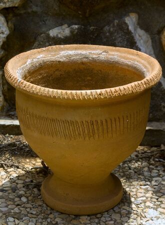 Old clay vase on the stone floorの写真素材