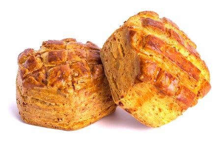 Two airy puff pastry buns with a beautiful baked crust and a great aroma on a whiteの写真素材