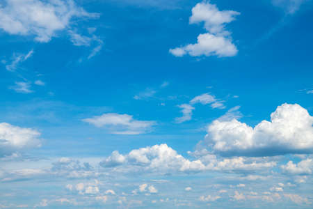 Blue sky background with white cloudsの写真素材