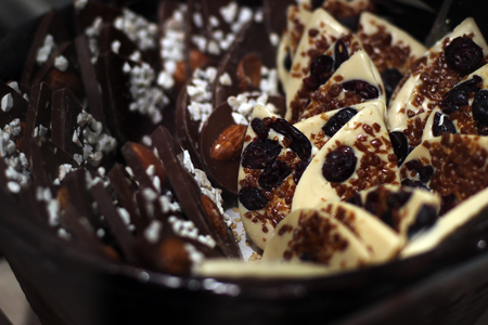 home made of white and dark chocolate candies. seeded raisins and nuts.