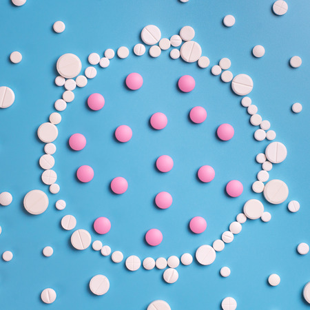 Pharmaceutical medicine pills, tablets on blue background. Copy space for textの写真素材