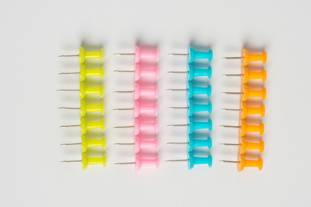 Colorful pushpins on white. Colored pushpins. Office accessories. Office supplies on white.