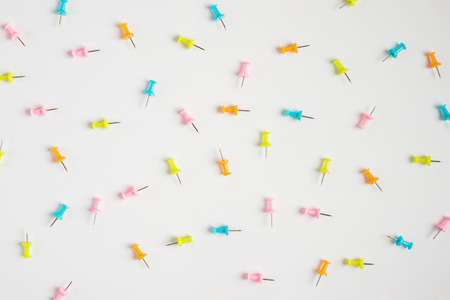 Colorful pushpins on white. Colored pushpins. Office accessories. Office supplies on white.