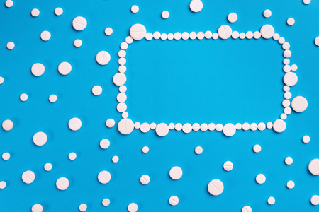 Pharmaceutical medicine pills, tablets on blue background. Copy space for textの写真素材