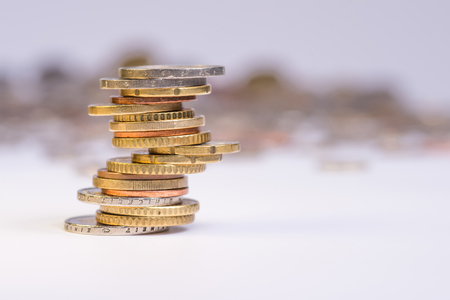 Euro coins stacked on each other in different positions. Copy space for textの写真素材