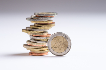 Euro coins stacked on each other in different positions. Two euros. Copy space for textの写真素材