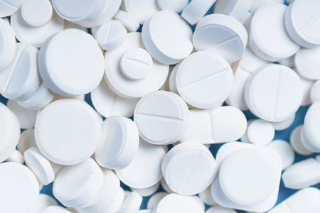 White pills or capsules on a blue background with copy space.の写真素材