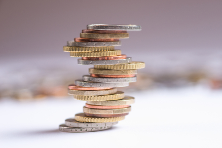 Euro coins stacked on each other in different positions. Copy space for textの写真素材