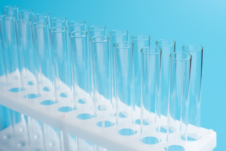 Glass test tubes in a stand on blue background. Laboratory test tubes,science background abstractの写真素材