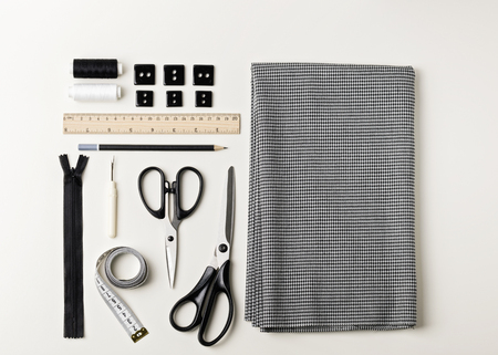 Everything for sewing in black and white. Fabric and thread, zipper and buttons, scissors and...