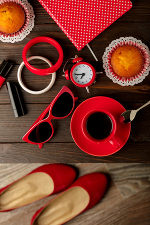 Cup of coffee with cupcakes, notepad, accessory, shoes and sunglasses. Selective focus.の写真素材