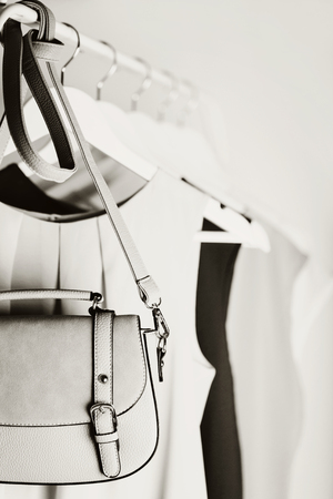 Black-and-white photo with the blur. Women's clothing on a white hanger. Selective focus.の写真素材