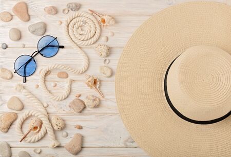 Sunglasses and hat on a light wooden background. Selective focus.の写真素材