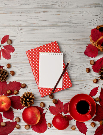 Autumn red leaves with apples on a wooden background. Flat lay concept.の写真素材