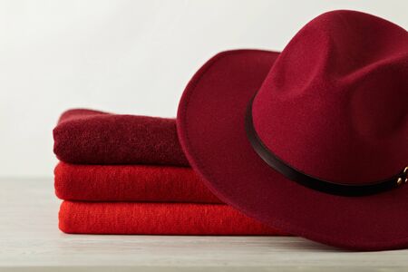 Fashion trend autumn winter. Clothing (sweaters) of different shades of red and crimson. Selective focus.の写真素材